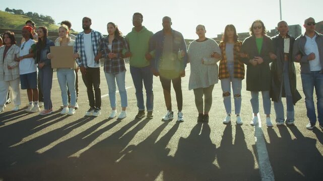 People are blocking the street as they stand united in peaceful protest