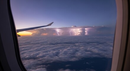 Airplane view of storm and lightning above clouds during a colorful sunset