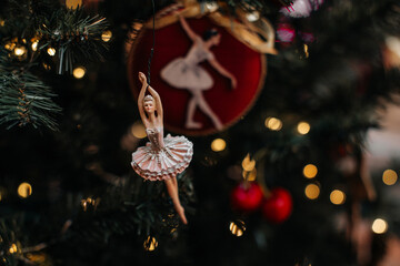 An elegant ballerina figurine hanging on a Christmas tree, unique New Year decor, gifts and souvenirs