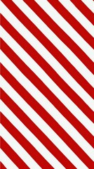 Obraz premium Red and white diagonal stripes form a seamless pattern, providing a clean graphic background texture for various design projects, web banners, and seasonal themes