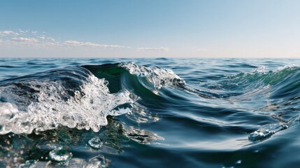 Close up of deep blue ocean wave cresting with white foam under a bright blue sky