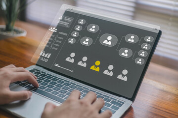 A person using a laptop with a digital organizational chart, highlighting employee management, HR analytics, recruitment selection, workforce planning, and modern human resource technology.