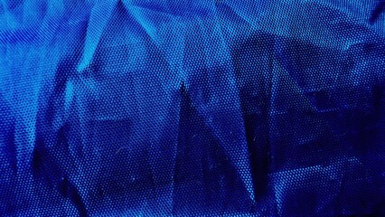 abstract blue wrinkled dotted texture close-up with gradient shades and mesh pattern as stock photo background