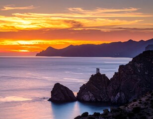 Coastal sunset view with jagged rock formations, tower, calm water, & colorful sky