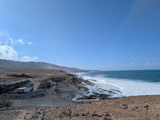 View of  rugged coastline, waves crashing against rocks on the East coast of Fuerteventura Spain 