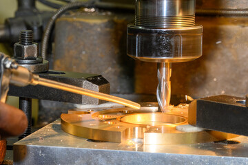 The hole boring  process on NC milling machine by flat nose end mill tool with brass ring parts.