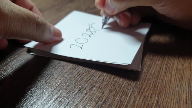 The year &ldquo;2025&rdquo; being crossed out and rewritten as &ldquo;2026,&rdquo; a simple symbolic moment representing new year transition, change, and forward-looking optimism.