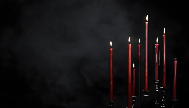 Atmospheric burning red taper candles in silver holders on dark black smoky background with copy space for gothic halloween or romantic candlelight dinner concept - Powered by Adobe