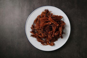 Close up of dried red cotton tree flowers (Kapok flowers) Heap of dried Dok Ngiew , Northern Thai food ingredient.