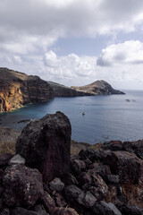 Dramatic volcanic cliffs and serene ocean view at Ponta de S&atilde;o Louren&ccedil;o, Madeira Island, Portugal &ndash; panoramic coastal landscape with sailboats, hiking trails, and wild natural beauty.