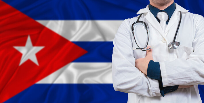 Male doctor with stethoscope on Cuba flag. Doctor holding stethoscope on Cuba flag