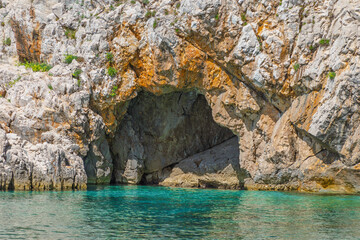 Rocky coastal cave overlooking pristine turquoise water