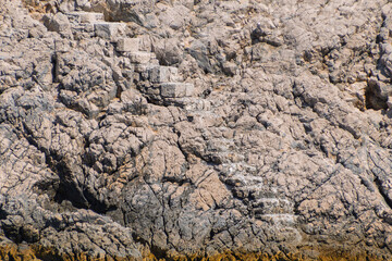 Ancient stone steps amidst rough rocky cliffs by the sea