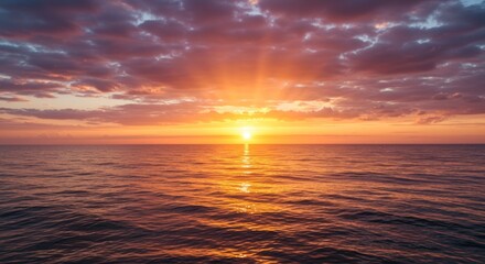 Fototapeta premium Ocean sunset with radiant sunlight and colorful sky reflections over the water natural landscape scene