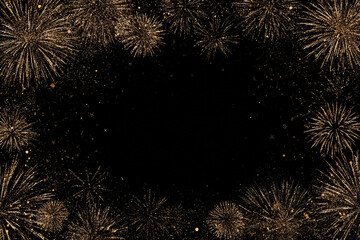 dazzling gold fireworks explode against a black night sky with scattered sparks