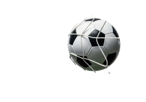 a classic telstar-style soccer ball frozen mid-impact, forcefully stretching a white nylon goal net on a transparent background with dramatic lighting. concept of definitive achievement