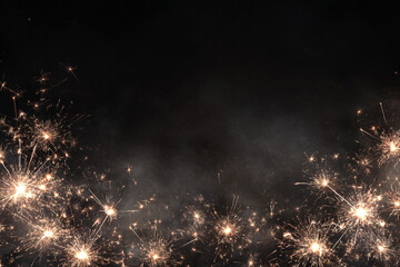 bright sparklers glow on a dark background creating a festive and celebratory mood