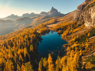 Fototapeta premium Alpine landscape of Lago di Federa and Croda da Lago peak surrounded by autumn forest in Dolomites, Italy