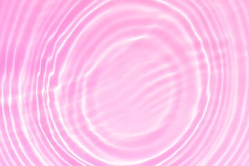 Pink water bubbles on the surface ripples. Defocus blurred transparent pink colored clear calm water surface texture with splash and bubbles. Water waves with shining pattern texture background