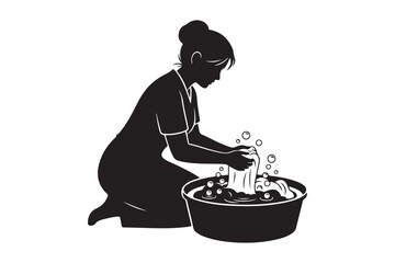 Silhouette of a woman washing clothes in a basin