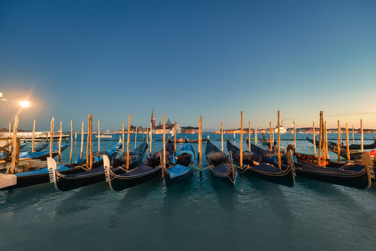 View of San Giorgio Maggiore with Gondola boat along the waterfront in Venice, Italy - Powered by Adobe