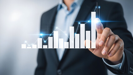 Businessman analyzing rising bar chart representing growth and financial success in business