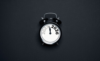 A clock showing the transition from 2025 to 2026 on a dark background representing a new year...