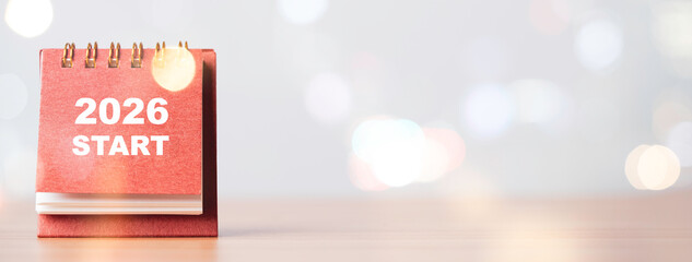 A desk calendar showing 2026 start with soft bokeh light representing the new year concept fresh...