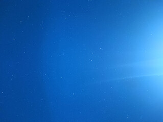 Deep Blue Night Sky with Scattered Stars and Bright Horizon