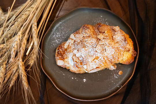 Close up delicious breakfast menu croissant and coffee cup on the wood table in the restaurant. - Powered by Adobe