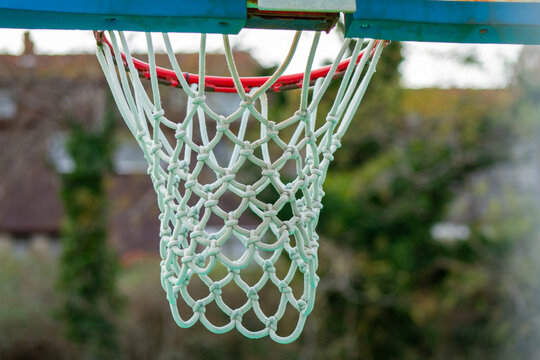 Close-Up Basketball Hoop with White Net – Orange Rim and Chain Macro