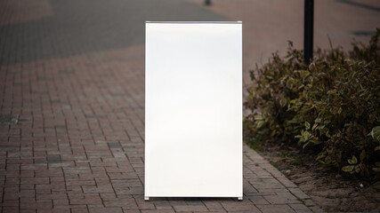 Blank white signboard on sidewalk