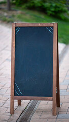 Blank chalkboard stand on sidewalk