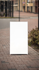 Blank white signboard on sidewalk