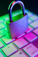 Cyber security lock symbolizing internet protection on a keyboard illuminated with colors