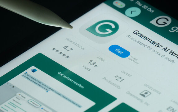 Dhaka, Bangladesh- 30 Oct 2025: Grammarly app on a iPad screen with a pen pointing at the install option.