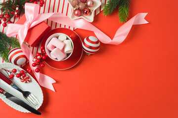 Merry Christmas and New Year background with bow, gift box, marshmallow and decorations. Top view, flat lay