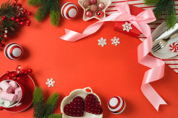 Merry Christmas and New Year background with bow, gift box, marshmallow and decorations. Top view, flat lay