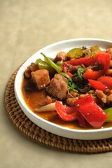 Homemade Kung Pao Chicken or Gong Bao or Kung  Po with bell pepper and peanuts on plate. Oriental food, Chinese tradition cuisine, food design