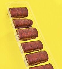 Mini Chocolate Cake Roll Swiss Roll on yellow background