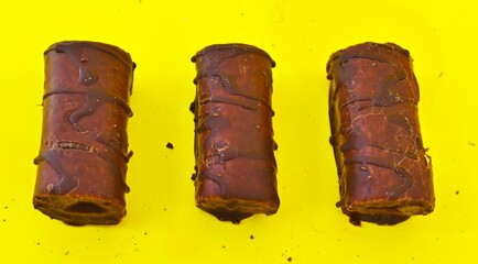 Mini Chocolate Cake Roll Swiss Roll on yellow background