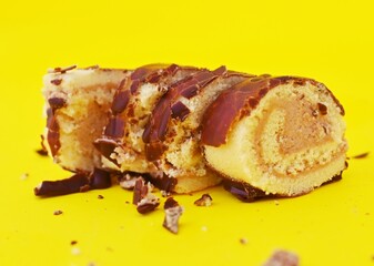 Mini Chocolate Cake Roll Swiss Roll on yellow background