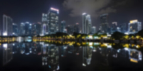 Obraz premium Night skyline reflection of city buildings by river under cloudy sky Blur photo Concept