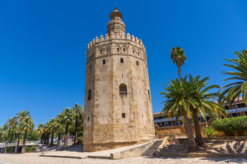 Fototapeta premium Sevilla, Spain - August 01, 2024: Golden tower Torre del Oro in Seville, Andalusia, Spain 