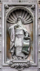 Detail of St. Isaac's Cathedral massive bronze gate featuring detailed sculptural reliefs of religious scenes