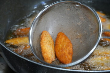 Korean jeon being fried in hot oil close-up