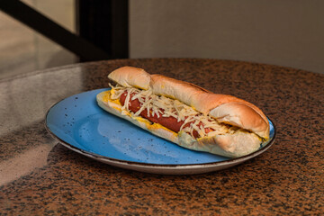 Hot dog with cheese on a plate
