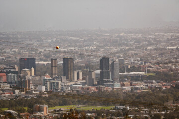 Bird's eye view on building exteriors houses and skyline of Adelaide outdoor on a foggy day with natural light during winter in Southern Australia with space for text.