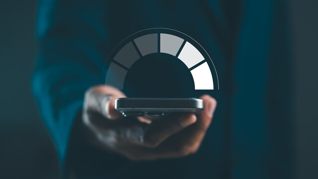 A hand holds a smartphone displaying a speedometer, symbolizing technology, connectivity, and performance metrics in a modern, sleek design. - Powered by Adobe