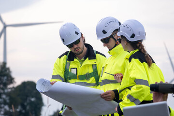 Construction team reviews plans at a wind farm site during the afternoon